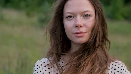 Close Up Portrait of Young Caucasian Woman Looking Into the Camera Outdoors