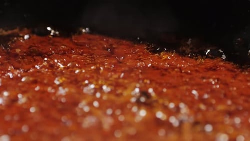 Simmering Orange Sauce Close Up