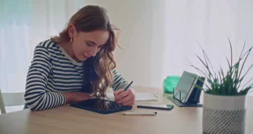 Woman Drawing on Tablet at Home