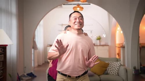 Group of Seniors Dancing Together in Home