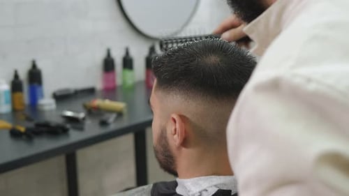 Barber Styles Hair with Brush at Trendy Shop