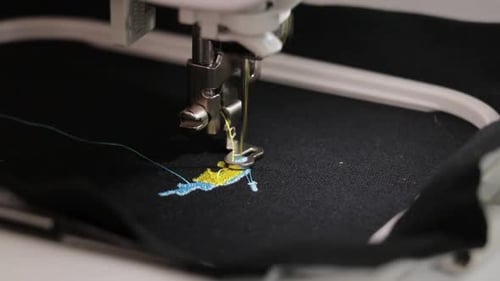 Fabric embroidering machine. Textile industry.