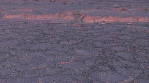 Sunset over frozen Lake Huron, serene snow-covered landscape in winter season