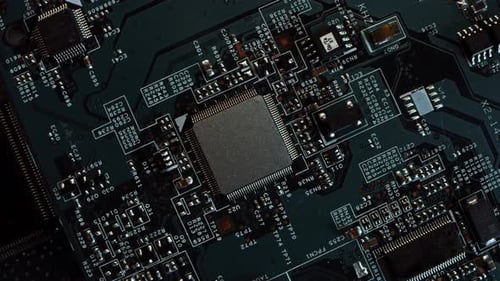 Focus on a Microchip, CPU Processor. Printed Circuit Board / Computer Motherboard with Components: