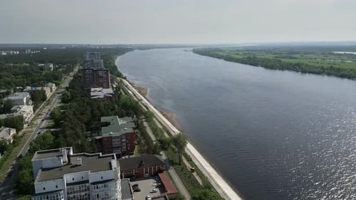 Stunning Aerial View of a Tranquil River Flowing Through a Beautiful Urban Landscape Scene Clip