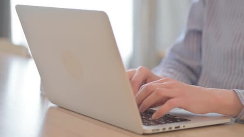 Close Up of Young Woman Typing on Laptop