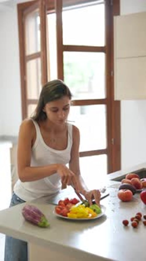 Woman in Kitchen Cuts Fresh Vegetables