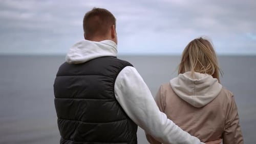 Affectionate Couple Embracing Near the Water