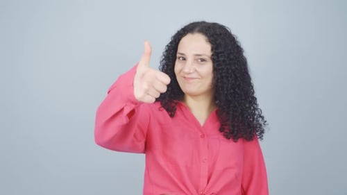 Woman Smiling and Giving Thumbs Up