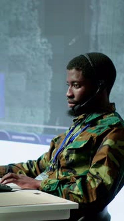 Vertical Video Team of Military Specialists in Command Post Monitoring Satellite Data