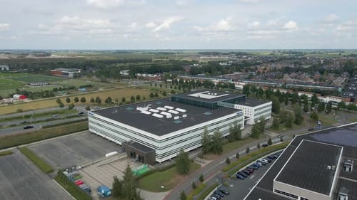 Jib up of a large office building near busy streets