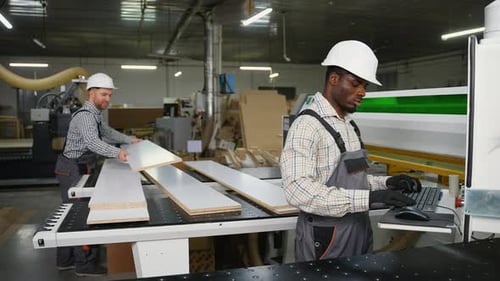 Team Cutting and Handling Wood Panels at Furniture Factory