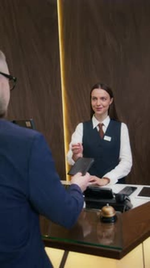 Guest Giving Passport to Hotel Receptionist for Checkin