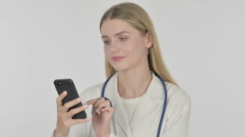 Young Doctor Using Smartphone in Hospital Setting
