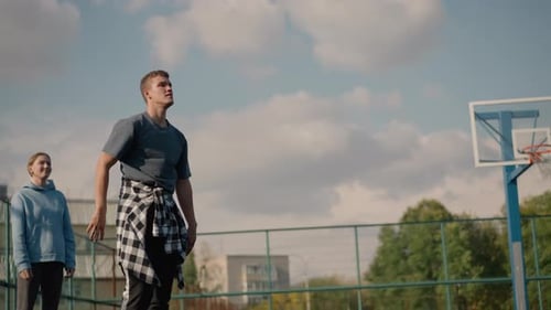 Young Man Hits Volleyball at Outdoor Court