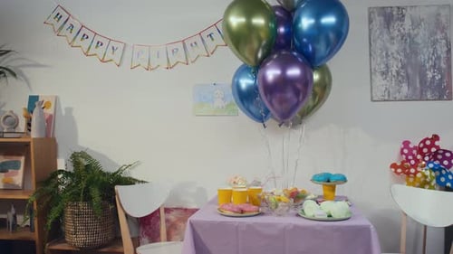 Festive Birthday Party Table with Balloons and Treats