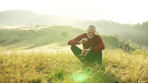 Senior Runner Relaxing in Morning Meadow