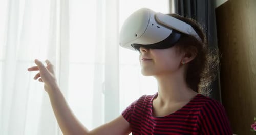 Child Wearing VR Headset Using Hand Gestures