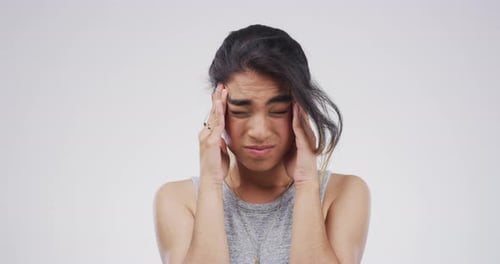 Woman Experiencing Headache with Hands on Head