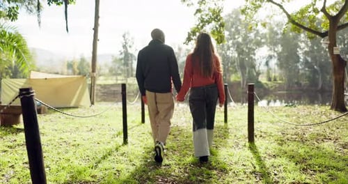 Couple Walking Hand-in-Hand by a Peaceful Pond
