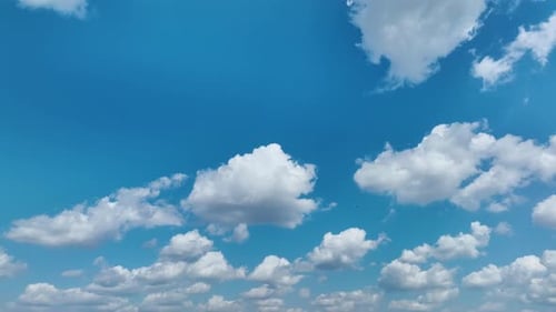 White Puffy Cumulus Clouds on Summer Blue Sky