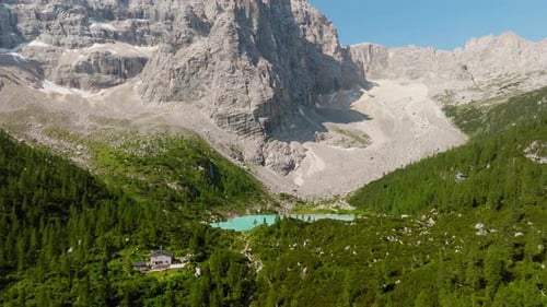 Lake Sorapis nestled among Dolomite peaks in vivid summer landscape