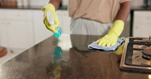 Adult Cleaning Kitchen Counter with Spray and Cloth