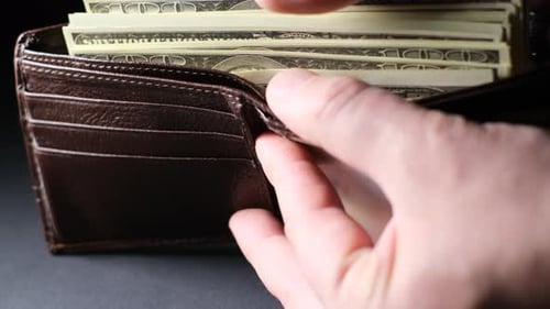 Wallet Filled With Stack of Hundred Dollar Bills