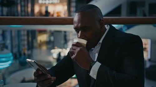 Middleaged African Entrepreneur Ethnic Man Worker Businessman Sitting in Cafe Cafeteria Looking at