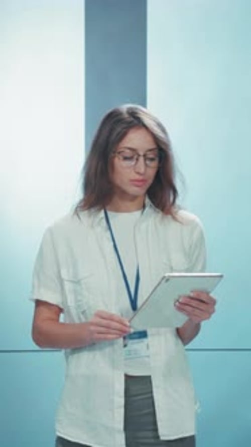 A Professional Woman Using a Tablet in a Contemporary Modern Office Environment Setting