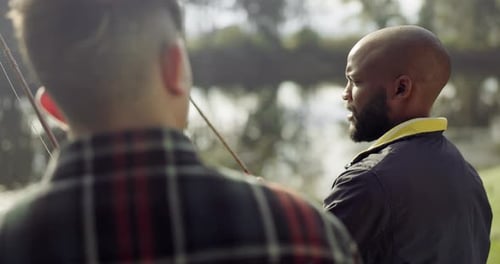 Fishing, lake and friends in nature talking on holiday, adventure and vacation together outdoors