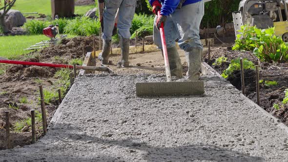 Workers raking freshly poured concrete. Slow motion, Industrial Stock ...