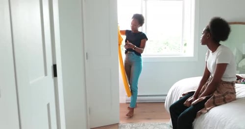 Two Women Choose Fashion Outfit at Home