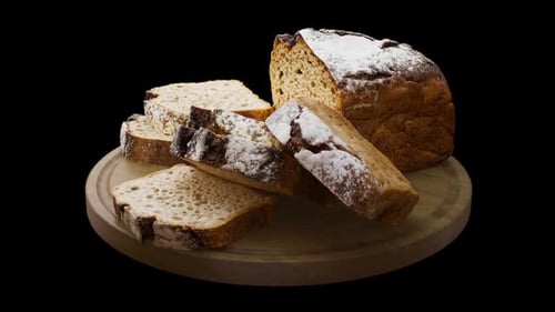 Rotating Freshly Baked Bread on a Wooden Cutting Board