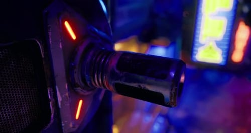 Futuristic Close Up of a Metallic Device with Neon Lights in a Vibrant Setting