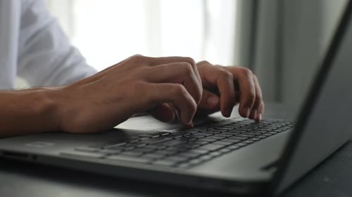 Closeup Cropped Shot of Unrecognizable Business Man Typing on Laptop Keyboard Working at Office Desk