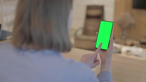 Young Woman Using Phone with Green Screen