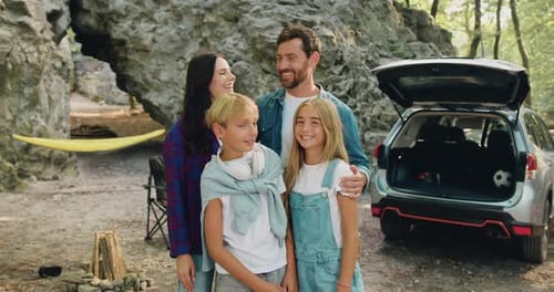 Happy Family Poses Together Near Rocky Outcrop