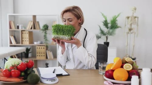 Woman Doctor Holds Microgreens in Office Setting