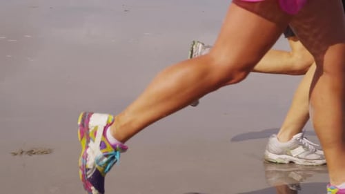 Closeup of Women Running on Beach