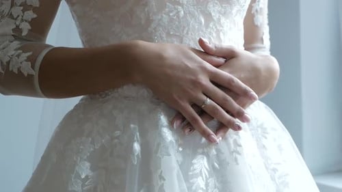 Bride in Elegant Wedding Dress Holding Hands