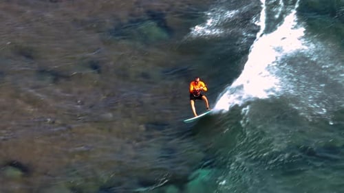 An Athlete on a Wave Board Rides the Big Ocean Waves of a Living Reef in the Indian Ocean