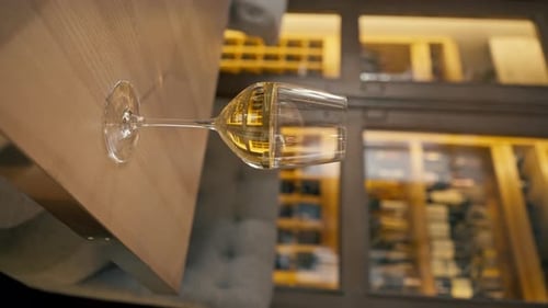 Vidéo verticale Gros plan d'un verre de vin blanc posé sur une table dans un restaurant italien