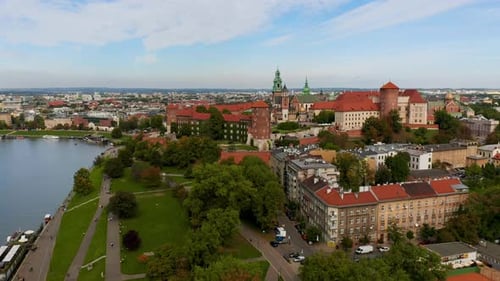 Drone footage (front view) of Wawel Royal Castle with tourists, Krakow, Poland