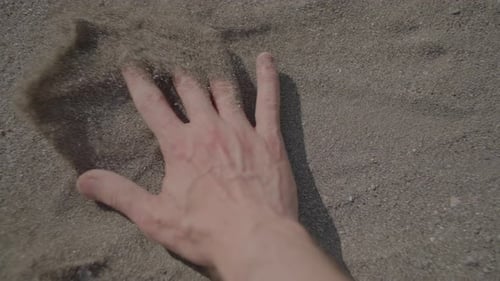 Hand Raking Coarse Sand on the Beach
