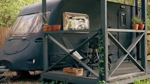 A mobile home with a terrace is located in country glamping site for relaxation and solitude nature