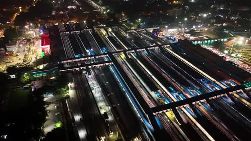 Drone view of cityscapes and train station at night in New Delhi, India