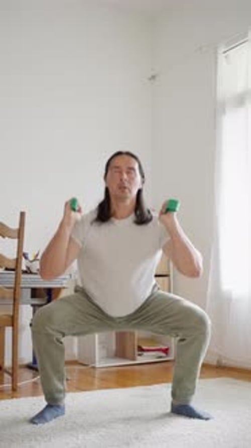 Young Adult Exercising with Resistance Band at Home