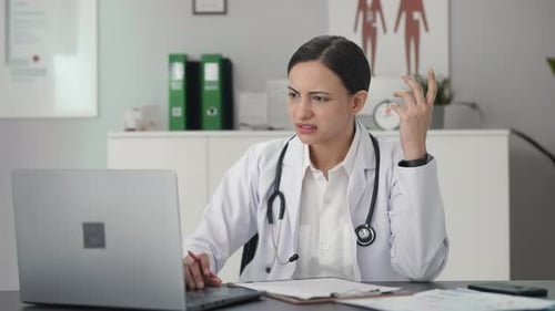Confused Indian female doctor student studying for exams