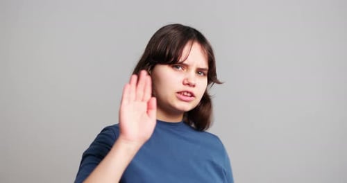 Teen Girl Saying No with Hand Up